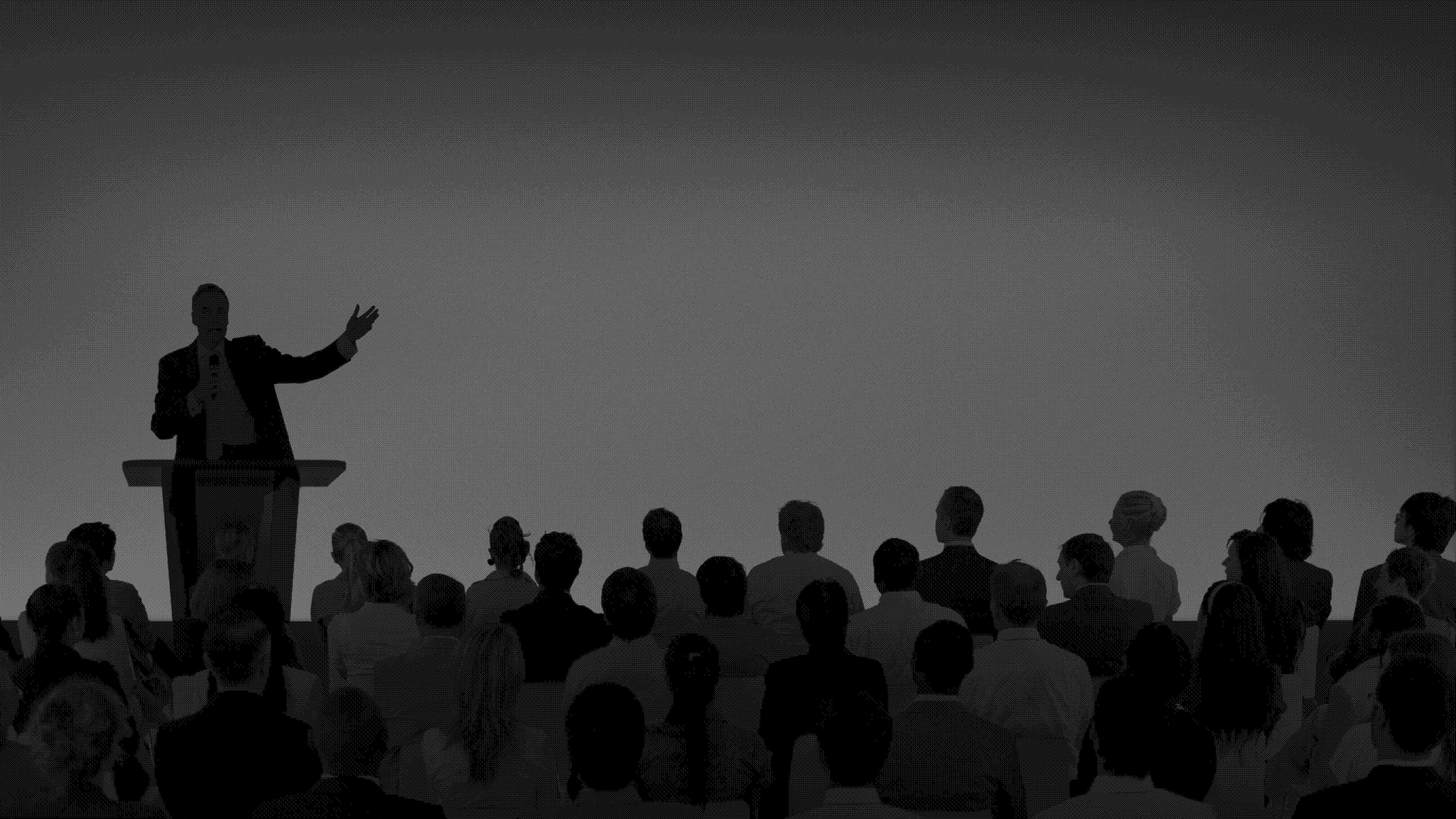 Corporate businessman giving a presentation to a large audience
